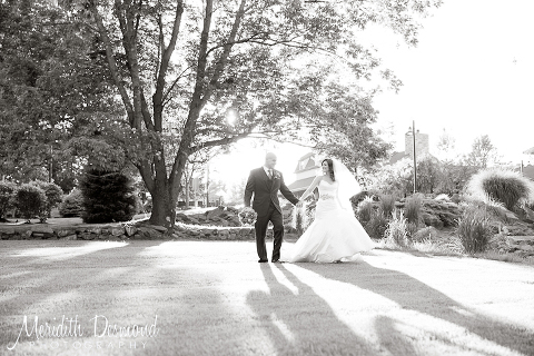 Bride and Groom walking under a big tree